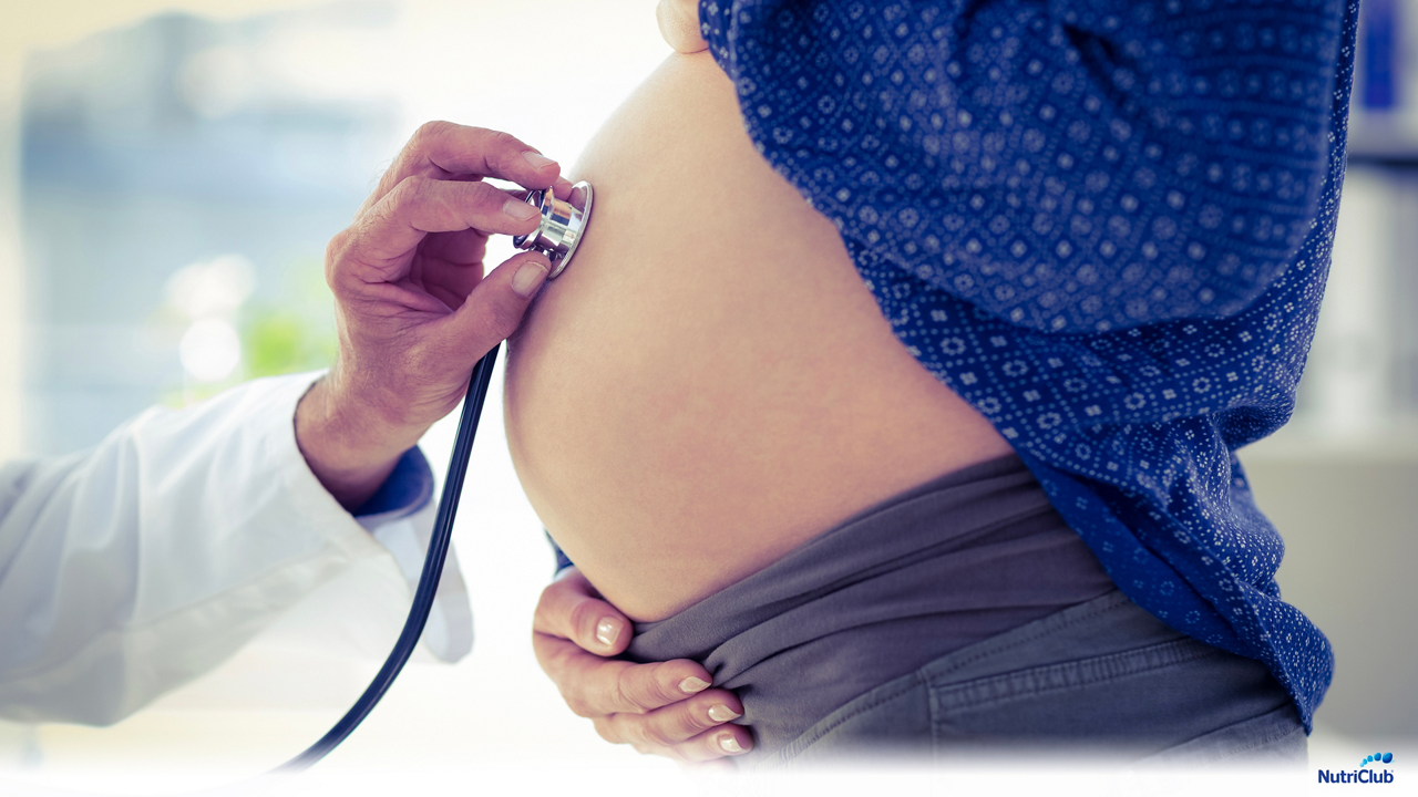 живот беременной слушают стетоскопом