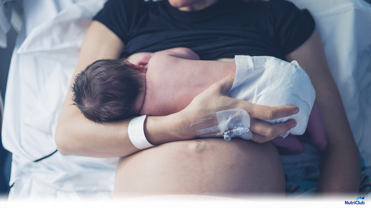 Woman breastfeeding newborn