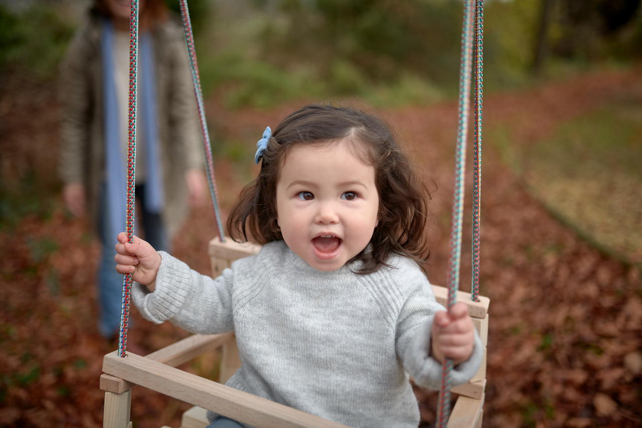 AptaGro toddler outdoors on swing