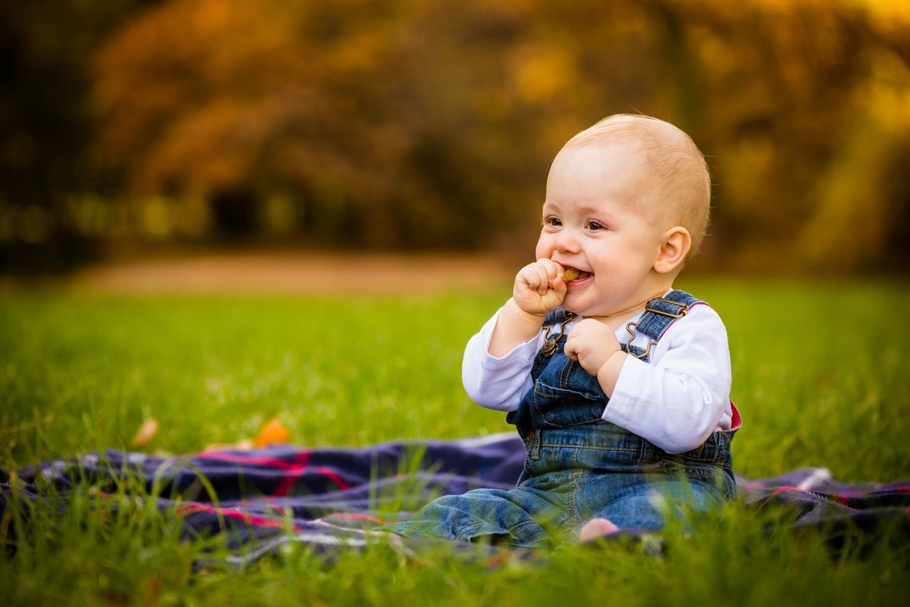 Baby eating food outdoors