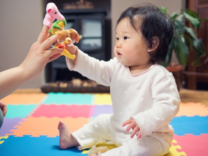 Baby playing with finger puppets