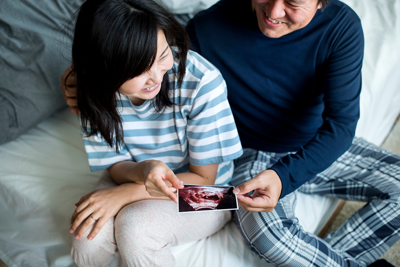 Couple looking ultrasound scan