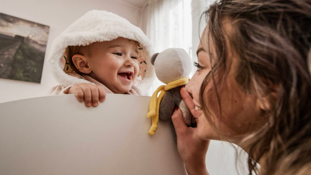 Frau spielt mit lachendem Baby 
