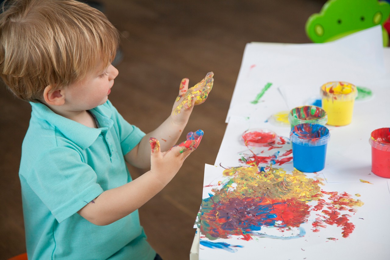 Toddler painting cups paint hands