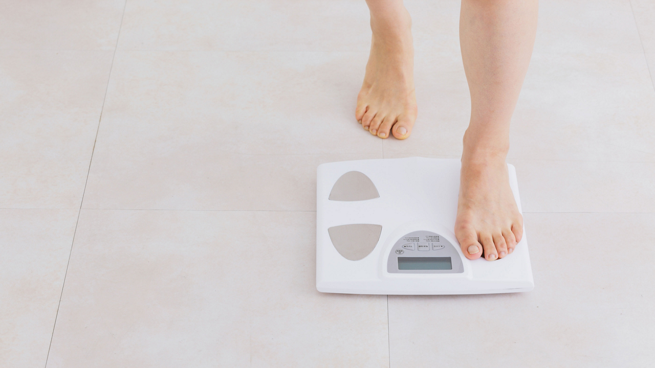 Putting foot on weighing scales 3840 2160