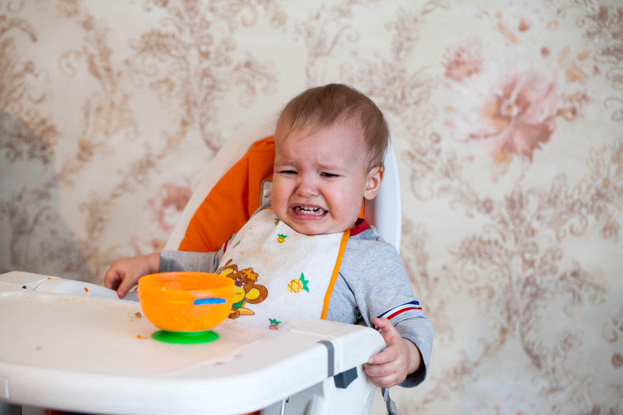 Unhappy baby crying highchair