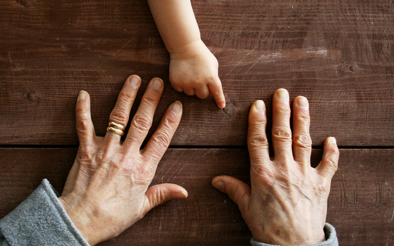 Young and old hands for adult covid info page