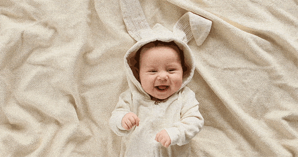 Baby in Hasenkostüm lacht
