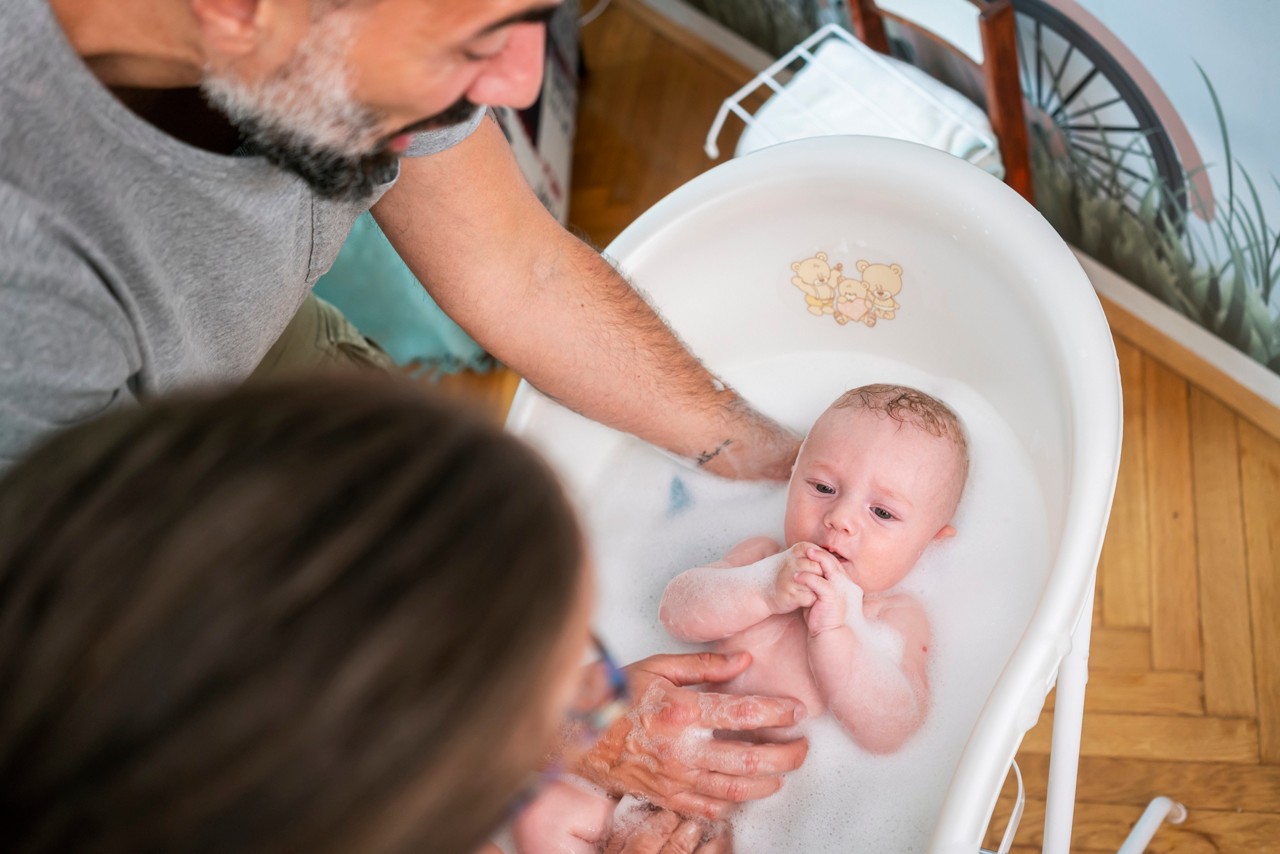 Baby bathing with his parent's