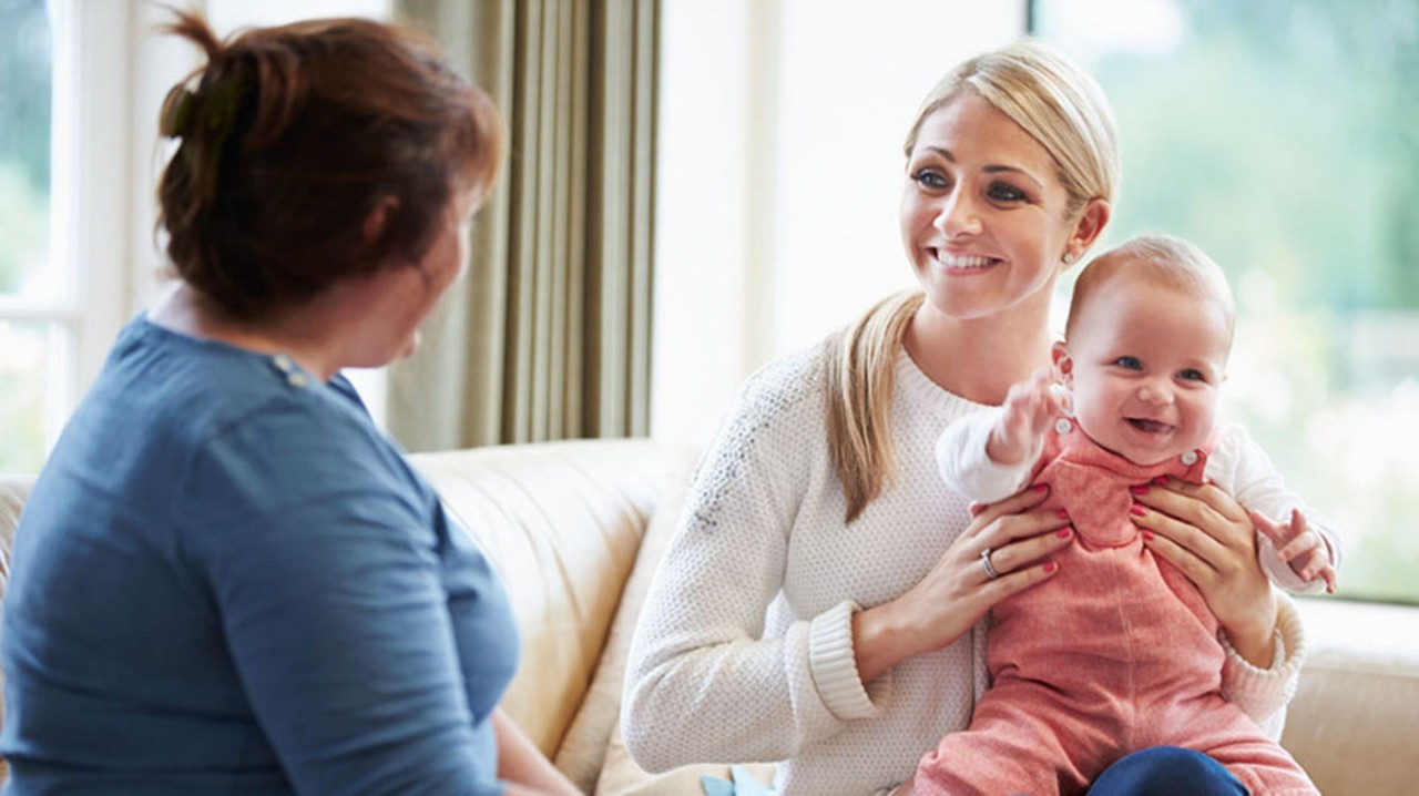 Baby and mum smiling with another woman