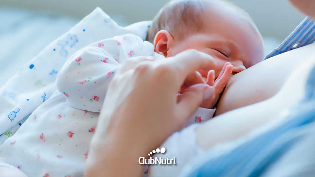 Breastfeeding baby on bed