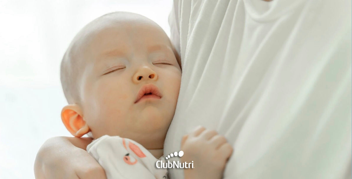 Breastfeeding baby on bed