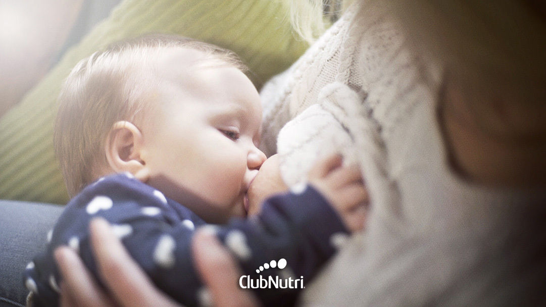 Breastfeeding baby on bed
