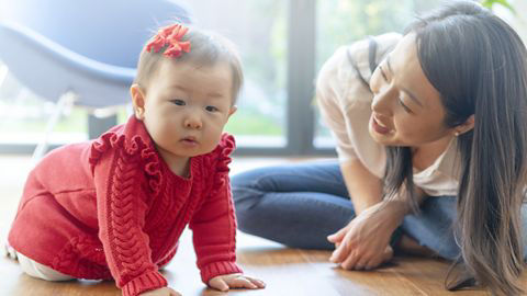 Mother playing with baby