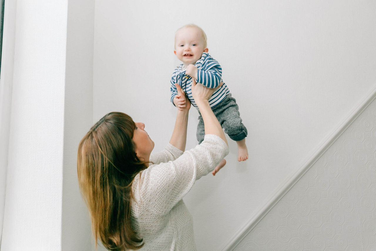 child with faltering growth carried by mom 