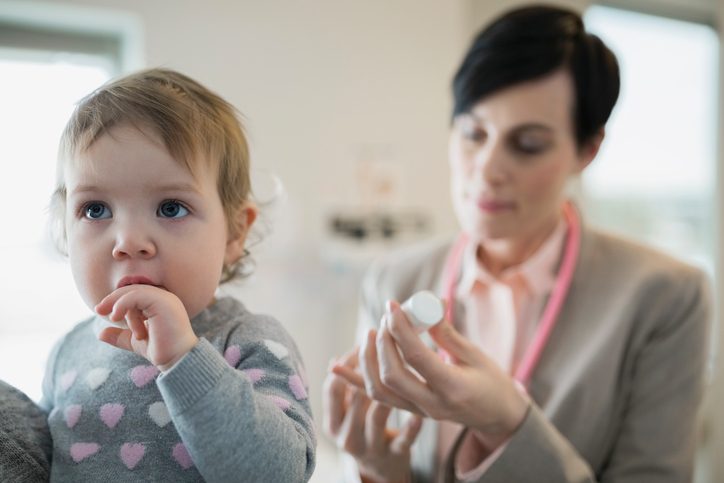 Pediatrician preparing vaccination for baby girl