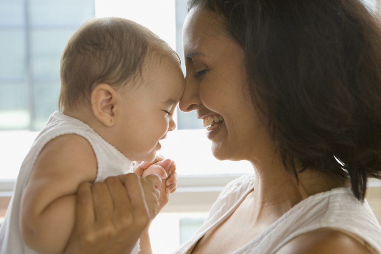 Mother and baby heads touching