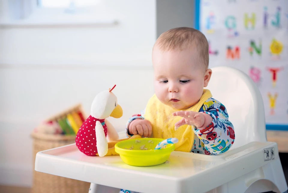 Toddler eating strawberries outside