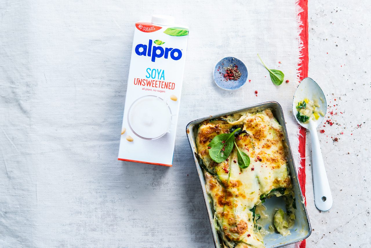 17EB0455-48C0-43B2-813318FD57EB06E7<br>A_NoSugars_NA_Master_Recipe_Image_vegetablelasagnapackshot___Drinks_Unsweetened_Soy_NA_TetraUHT_1l_HR_horizontal.tif<br>Mean Green Veggie Lasagne

Easy-peasy pasta layers with creamy veg and Alpro Soya Unsweetened Drink

"250ml Alpro Soya Cuisine 
150ml Alpro Soya Unsweetened Drink
1 shallot
2 courgette
2 leeks
2 cloves of garlic
Tarragon
200g spinach
1/2 lime 
250g mozzarella, grated
16 fresh lasagne sheets
A pinch of nutmeg
Sea salt and white pepper"

"1.	Preheat your oven to 180ºC. Finely dice the shallot, leeks and garlic. Thinly slice the courgette lengthwise. 
2.	Make the yummy sauce. Fry the shallot, garlic and leek until the shallot is translucent. Add the spinach and cook just until it’s wilted. Add the Alpro Soya Cuisine and Alpro Soya Unsweetened Drink and season with sea salt, pepper, tarragon, nutmeg and lime until it tastes just how you like it.
3.	Arrange alternating layers of sauce, lasagne leaves, zucchini slices and half the mozzarella in a baking dish and scatter the rest of the mozzarella over the top.
4.	Bake on the middle rack for about 30 minutes until golden brown and bubbling.  
An easy win dinner that’s sure to be a family favourite! "