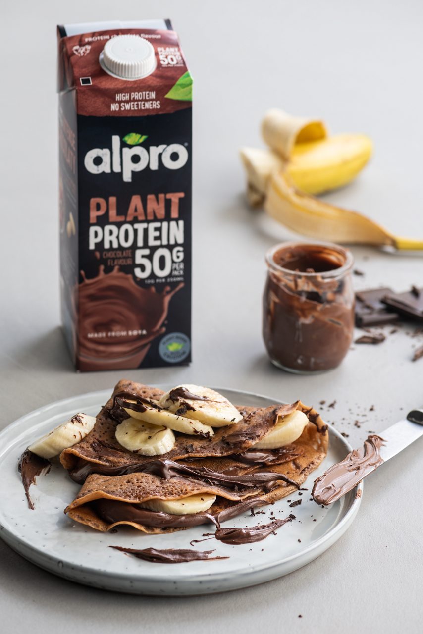 CC4EA5A9-98EC-4359-820E911788966A98<br>A_FYY_NA_Master_Recipe_Image_ChocoBananaPancakes_NA_Drinks_HighProtein_Soya_Chocolate_TetraUHT_1L_HR-107.tif<br>vegan_chocolate_banana_crepes_title	Vegan chocolate-banana crepes
vegan_chocolate_banana_crepes_subtitle	served with Alpro Chocolate protein drink
vegan_chocolate_banana_crepes_ingredients	"
270 g cake flour, sieved
500 ml Alpro Chocolate protein drink
2 tbsp Alpro baking and frying, melted
1 tbsp vanilla essence
2 tbsp dark chocolate spread
1 banana, cut into slices"
vegan_chocolate_banana_crepes_preparation	"""In a mixing bowl, combine the cake flour, Alpro Chocolate protein drink, melted Alpro baking and frying and vanilla essence.
Mix using a whisk till no lumps are visible.
Heat a non-stick pan with Alpro baking and frying or vegetable oil and add batter to cover the pan. Leave to cook for 2 minutes and turn. Bake till all the batter is done.
Fill the pancakes with chocolate spread and banana."""
vegan_chocolate_banana_crepes_tags	Vegan 
vegan_chocolate_banana_crepes_url	/Vegan-chocolate-banana-crepes
vegan_chocolate_banana_crepes_info	(Recipe type: Dessert/snack (Prep time: 10 min) (baking time: 10 min) (cooling time: X ) (servings: for 10 pancakes) (season: All season)
vegan_chocolate_banana_crepes_lactosetip	xx
vegan_chocolate_banana_crepes_veggietip	xx
vegan_chocolate_banana_crepes_trendtip	xx
vegan_chocolate_banana_crepes_glutentip	Use gluten-free flour
vegan_chocolate_banana_crepes_product	Alpro Chocolate protein drink
vegan_chocolate_banana_crepes_searchterms	Alpro, Alpro recipe, pancakes, healthy pancakes, chocolate pancakes, banana pancakes, crepes, french crepe, french pancake, chocolate, banana