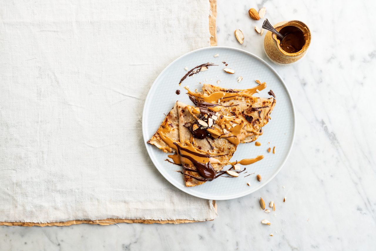 FCCFA4DF-D201-4B3B-84CC76F4DD25118B<br>ALPRO Almond Pannekoeken -255.tif<br>Vegan French Crêpes with Chocolate & Almond 
Flipping fabulous crêpes, made with Alpro Almond drink
"800ml Alpro Almond drink
300g plain flour
1 tsp baking powder
1/2 tsp salt
5 tbsp cane sugar
1 tbsp cornstarch 
2 tbsp sunflower oil 
1 tsp ground cinnamon 
1/2 tbsp vanilla essence
To cook: plant-based butter/spread

Toppings:
Peanut butter
Melted vegan chocolate (70%+)
Toasted almonds
Red fruits (optional)"
"1. Make the batter. Put all the ingredients apart from the spread in a blender and whizz until smooth. Easy peasy!
2. Melt a knob of plant-based spread in a pancake skillet and ladle in a thin layer of batter. Flip when you see bubbles appear and pile up the cooked crêpes on a plate – keep them warm until you're ready to serve. 
3. Repeat until all your batter is used up.
4. Serve hot, folded into quarters, topped with dollops of peanut butter, melted chocolate and a scatter of toasted almonds. Bon appetit!"
lactose free, veggie, vegan
/vegan_french_crêpes
(Recipe type: SNACK/DESSERT (Prep time: 10 min) (baking time: 30) (servings: +/- 16 pancakes) (season: all seasons)