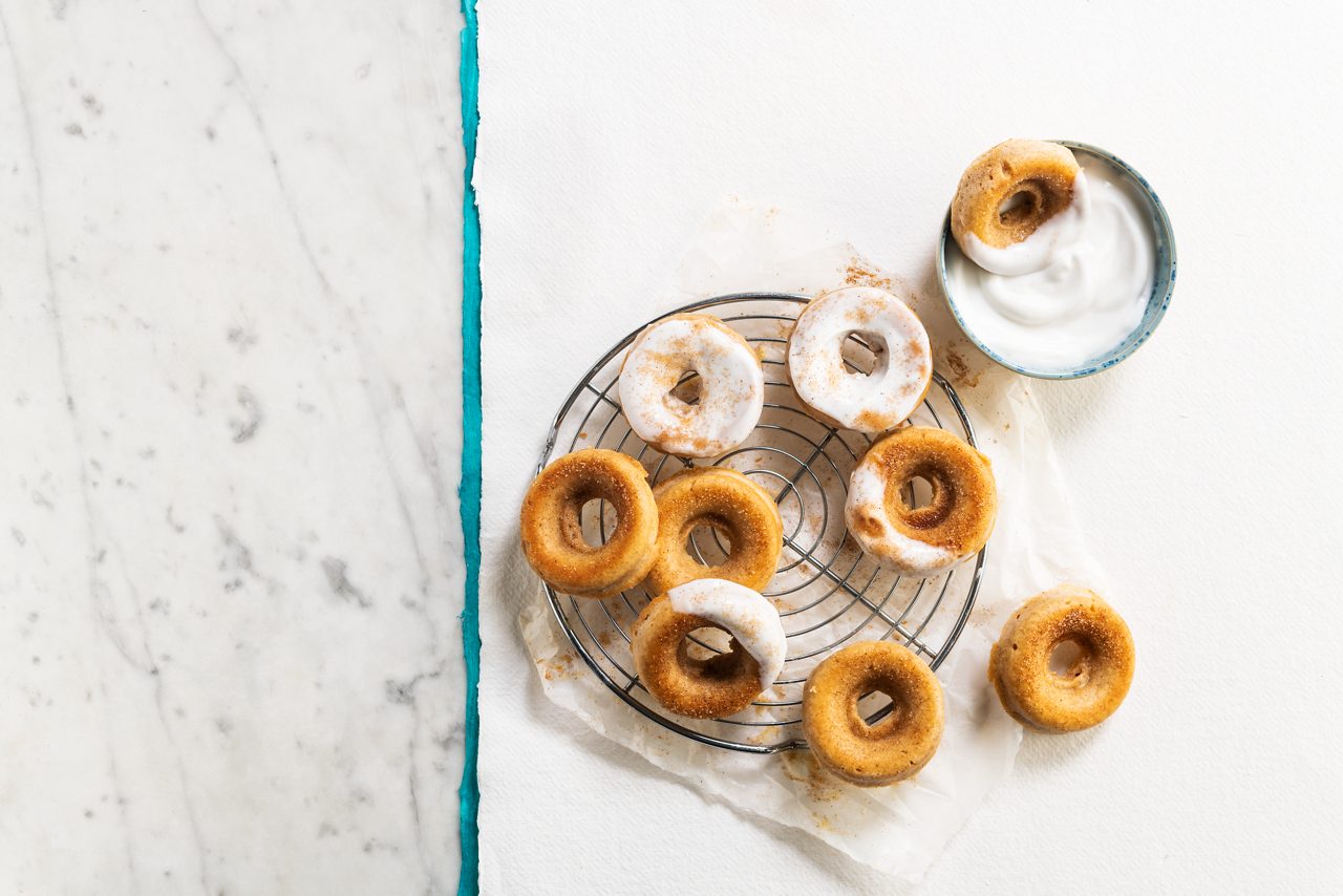 D9FA1BC9-482E-48BF-886B1A45F0C3AB47<br>A_GFY_NA_Global_Recipe_Image____GreekStyle_NA_Coconut_NA_Pot_400g_HR_BreakfastDonuts_3x2.tif<br>Breakfast donuts 

Divine donuts and a dollop of Alpro Greek Style Coconut.  Deelish! 

Ingredients:
150g plain flour
60g fine castor sugar
1 tsp baking powder
Pinch of salt
½ tsp ground cinnamon
100g + 2 tbsp Alpro Greek style Coconut 
100ml Alpro Oat drink
1 tbsp applesauce
1 tbsp Alpro margarine, melted
1 tsp pure vanilla extract
Topping:
40 g granulated sugar
1 tsp ground cinnamon
6 tbsp Alpro margarine, melted                                                                                                                                                                                                                                                    Alpro Greek style Coconut, for dipping 

1.	Start by preheating your oven to 170°C and spraying a donut pan with non-stick spray.
2.	In a large bowl, stir together the flour, sugar, baking powder, salt and cinnamon. Then pour in the Alpro Greek Style Coconut, Alpro Oat drink, applesauce, melted  margarine and vanilla . Give it a good mix with a large wooden spoon until you have a batter just like cake batter – not too thick but not runny, either.  
3.	Spoon the batter into the donut pan. Or pour it into a large ziplock bag, cut a hole in the corner and pipe the batter into the pan. Whichever way you do it, just stop when it's about 3/4 full. Overfill, and you might lose the hole from your donuts as they rise and expand in the oven.
4.	Bake for 20-25 minutes or until the edges turn lightly golden brown. Pans and ovens vary, so they could take a few extra minutes to bake. Be patient! Leave them in the pan for 2 or 3, then carefully take them out and move to a wire rack to carry on cooling.
FOR THE TOPPING:
5.	In a medium bowl, stir together the topping sugar and cinnamon, and melt the Alpro margarine in a separate bowl. 
6.	Dip the donuts into the melted margarine, both sides or just one side if you like. Then dunk the donut into the cinnamon sugar mixture to coat. Proudly serve, with an extra dollop of Alpro Greek Style Coconut on top. Best enjoyed straightaway, or on the same day you make them. If you do have any leftovers, they'll keep for two days at most, covered and at room temperature. But we guarantee they're just too yummy to hang around that long!

(Recipe type: dessert/breakfast/snack (Prep time: 10 min) (baking time: 30 min) (cooling time: x min) (servings: 10 pancakes) (season: all year)
! No GFY claim possible !

Caption: Chef, you’ve been pulling donuts around the kitchen like there’s no tomorrow, and now they’re screaming out to be nibbled. “Do-nut forget the ground cinnamon,” you said, and then you served them up in plant-based style! (leaf, chef emoji, leaf)
