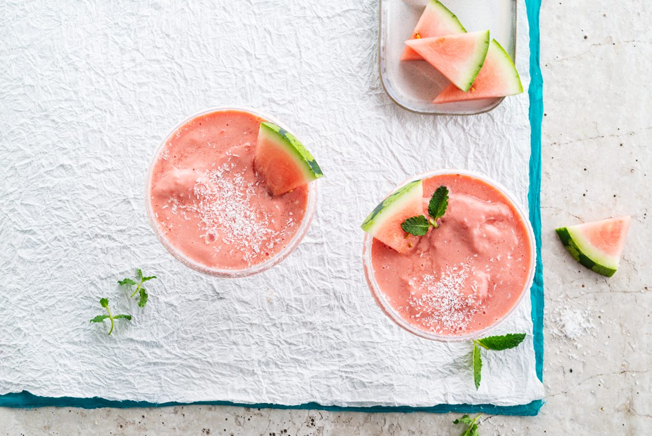 DD5CDF4F-B7D6-4F2F-8874F94926B731C4<br>A_GFY_NA_Master_Recipe_Image_WatermelonMocktail_3x4__Drinks_NA_Coconut_NA_TetraUHT_1l_HR_horizontal-190.tif<br>Virgin Watermelon Margarita 
Whip up this watermelon wonder with Alpro Plain with Coconut soya alternative to yogurt & Alpro Coconut drink 
"250g Alpro Plain with Coconut soya alternative to yogurt
100ml Alpro Coconut drink
450g watermelon (for freezing) + extra to decorate
1 lime (juice) 
5g mint leaves 
3 tbsp dessicated coconut "
"1. Chop the watermelon into small cubes, removing all the pips. Pop into a freezer-safe container, and freeze. 
2. Once they’re frozen, they’re ready to go into a blender along with the Alpro Plain with coconut and Alpro Coconut drink, the lime juice and mint leaves. Blitz until smooth and slushy. (if you don’t have a blender, a jug and a hand-held wand will do just as well.) 
3. Decorate your glasses by dipping the rims in water and then into the desiccated coconut. 
4. Pour in the mocktail and garnish with small slices of watermelon and mint leaves. Cheers!"
lactose free, veggie, vegan, gluten free
/frozen-watermelon-mocktail
(Recipe type: DRINKS  (Freezing time: 3hours) (Prep time: 15 min)  (servings: +/- 4 persons) (season: spring - summer) (pool: 1) NOT TO BE TRANSLATED
/
/
/
/
Alpro Plain with Coconut soya alternative to yogurt, Alpro Coconut Drink
Alpro, Alpro recipe, coconut, drink, mocktail, frozen, watermelon
