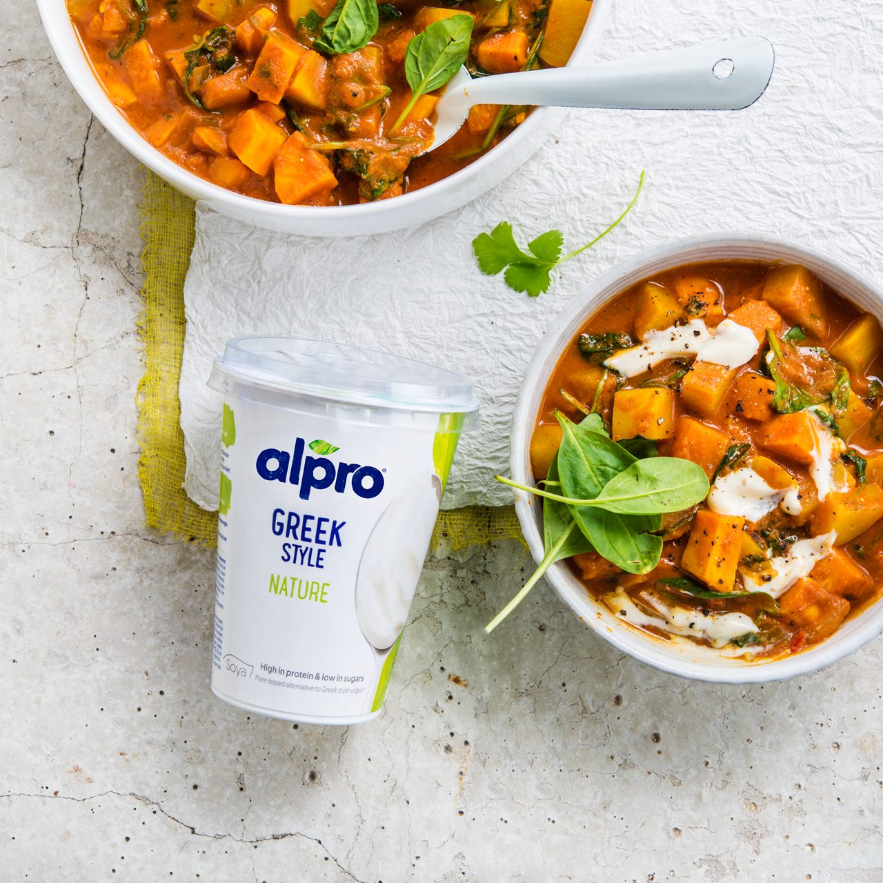 B51CF799-624E-4F04-8D9F6239A15CBA6C<br>A_NA_NA_Master_IG_Image_vegetablestewpackshot___GreekStyle_NA_Soy_NA_Pot_400g_HR_1x1.tif<br>Vegetable Stew

Warm up with this wholesome, hearty stew made with Alpro Plain Soya alternative to Greek Style yogurt

"220g Alpro Plain Soya alternative to Greek Style yogurt
600ml water
900g vegetables: potato, pumpkin and sweet potato
200g spinach
2 onions
2 garlic cloves
4cm ginger, grated
½ red chilli pepper (optional)
500ml tomato passata
1 ½ tbsp garam masala or ras el hanout
1 tbsp curry powder
1 tsp turmeric
1 lime, juice
Fresh coriander
2 tbsp olive oil or coconut oil
Salt & pepper"

"1.	First peel the veggies and cut into equal sized chunks. Finely chop the onion and chilli; grate the ginger and crush the garlic.
2.	Next, heat the oil and fry onion, garlic, ginger and chilli until the onions are translucent. Add the spices and cook for 1-2 minutes, stir-frying to release all the wonderful aromas. Add all the veggies (except the spinach), tomato passata, water and coriander.
3.	Let it simmer for 20-30 minutes on a low heat, stirring frequently until the potatoes are soft. Now add the spinach and Alpro Plain Soya alternative to Greek Style yogurt and simmer for a further 2 minutes just to wilt the spinach.
4.	Season with salt and a little lime juice. Serve steaming hot, sprinkled with a few extra fresh coriander leaves if you like. A super-sustaining, one pot meal in a bowl!"