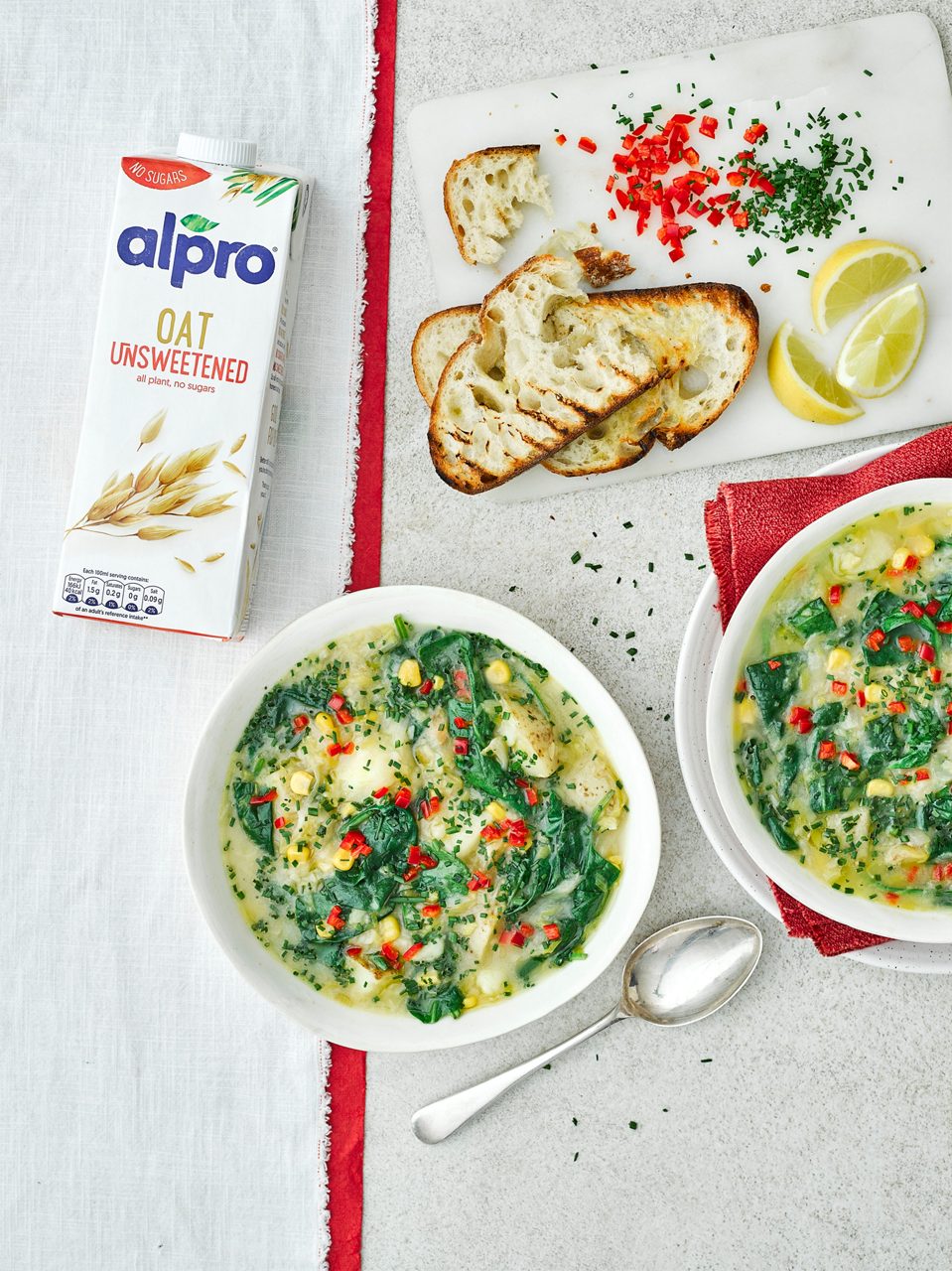 A693F813-D5A6-4A29-9362DC97390AC508<br>R+T-Alpro_UnsweetenedRecipes-Chowder_02586.jpg<br>Serves: 4
Total time: 1 hour

Ingredients: 
Olive oil, for frying
2 onions, finely sliced
3 medium leeks, finely sliced
2 garlic cloves, crushed
3 Maris piper potatoes (700-800g), scrubbed and 1cm dice
300ml Alpro Oat Unsweetened drink
1.2L vegetable stock 
150g tinned sweetcorn, drained
150g spinach
1 lemon, juice and zest
3 tbsp chives, finely chopped
1 red chilli, finely diced

To serve: 
Bread 
Lemon wedges 

Tip: the potatoes soak up liquid as the soup sits, top up with a little extra hot stock or boiling water if the liquid is absorbed. 

Method:
1.	In a large deep saucepan, heat a generous glug of oil over a medium heat. Add the onions and leeks and gently fry for 10 minutes, stirring regularly. Add the garlic, flour and potatoes and fry for 3-4 minutes stirring, until they start to cook through and the flour has coated the vegetables. 
2.	Stir in the Alpro Oat Unsweetened drink and stock, season and bring to a simmer, stirring regularly. Pour in the sweetcorn and lemon and bring to a simmer. Simmer for 30-40 minutes until the vegetables are tender and the soup coats the back of a spoon. Season to taste, stir in the chives and serve with bread and extra lemon wedges.