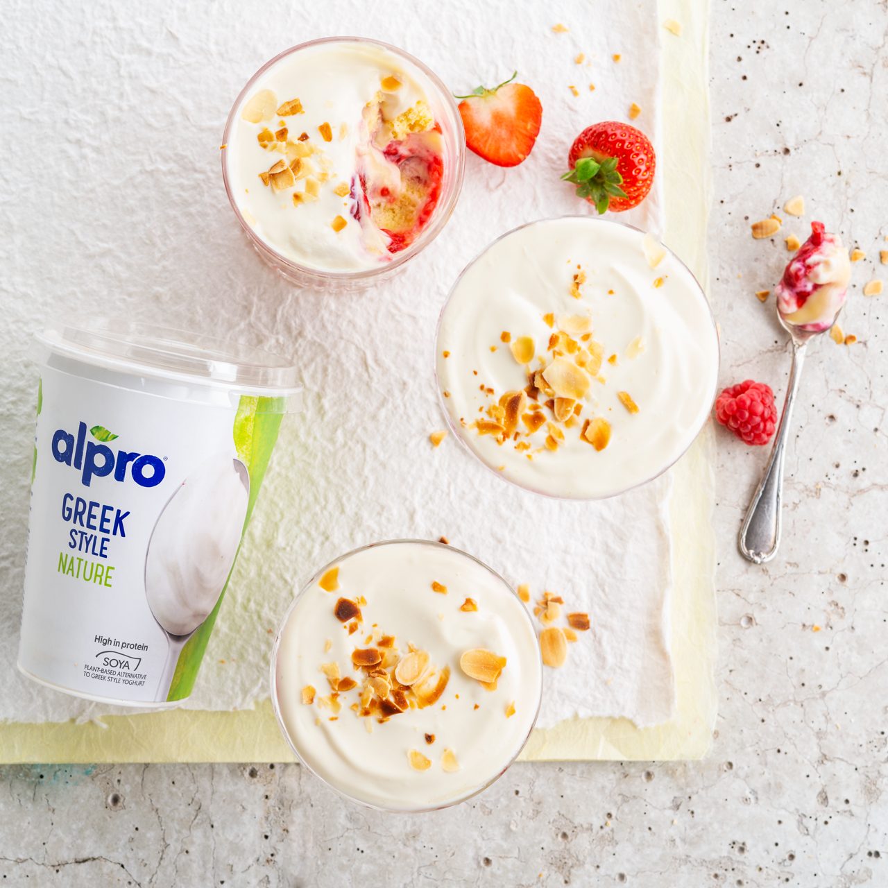 3BD1633B-7D5F-4BB9-93D616CBDB57BF33<br>A_GFY_NA_Master_Recipe_Image_SummerFruitTrifle_1x1__Dessert_NA_Vanilla_NA_Pot_250g_HR_horizontal-348.tif<br>Summer Fruit Trifle 
A fresh, fruity finish to a meal made with Alpro Desserts Vanilla + Alpro Plain plant-based alternative to Greek style yogurt
"For the sponge 
3 eggs
75g caster sugar
75g self-raising flour
1 tsp vanilla extract
1 tblsp boiling water
The rest
400g fresh strawberries & raspberries (add 4-6 tbsp water) or frozen fruit (defrosted)
6 tbsp kirsch or amaretto liqueur (optional), or use orange juice
525g Alpro® Desserts Vanilla 
400g Alpro® Plain plant-based alternative to Greek style yogurt
25g flaked almonds, toasted"
"1. Get ready. Pre-heat your oven to 180ºc/170ºc fan/gas 4, and grease or line a 23 x 23 x 6 cm square cake tin. Find yourself a pretty glass bowl to put your trifle in. (18-20cm x 10cm deep is the perfect size, and the glass will show off all your lovely layers.) Toast your flaked almonds in a shallow frying pan over a medium heat, turning them with a spatula to prevent burning as they cook really quickly. It’s well worth that little extra effort as they taste so wonderful toasted and the extra crunch is an added bonus. As soon as they start to colour tip out of the pan and let them cool down.
2. Make the sponge. Separate the eggs into two bowls. Put the whites into a medium bowl and whisk until they form soft peaks, then carry on whisking you gradually add the sugar then finally add the yolks
3. Sieve the flour and gently fold it into the mixture with a metal spoon, keeping in that all-important air. Add the vanilla extract and the boiling water around the edge of the bowl then carefully fold it in, too. Pour into your tin and bake in the oven for 12-15 mins, until well risen and ‘springy’ when touched, then let it cool down on a wire rack.
4. Over a low heat, cook the fresh fruit in a small saucepan along with 4-6 tbsp water until soft, taking care not to let the water evaporate. Then put it to one side to cool. (Frozen fruit won’t need cooking.)
5. Now the fun part, putting all the layers together. Cut the sponge into 9 pieces and cut each slice horizontally through the middle, (so you have 18 pieces of sponge). Using half of the slices, line the base and sides of your bowl. Soak the sponge with the liqueur or orange juice, making sure it’s even.
6. Spoon half the fruit over the first layer of sponge. (If you’re using frozen berries, you won’t need all of their juice.) Now add the rest of the sponge and arrange the other half of the fruit on top of that.
7. Spoon on the Alpro® custard followed by a generously thick layer of the Alpro® Plain plant-based alternative to Greek style yogurt. Sprinkle the toasted almonds over the top, and if you have some fresh fruit to hand that’ll just finish it off nicely."
lactose free, veggie
/summer-fruit-trifle
(Recipe type: DESSERTS (Prep time: 20 min) (cooking time: 15 min) (baking time: x min) (cooling time: x min) (servings: +/- 6 persons) (season: all year) (pool: 1) NOT TO BE TRANSLATED
/
/
/
/
Alpro Desserts Vanilla + Alpro Plain plant-based alternative to Greek style yogurt
Alpro, Alpro recipe, desserts, trifle, summer dish