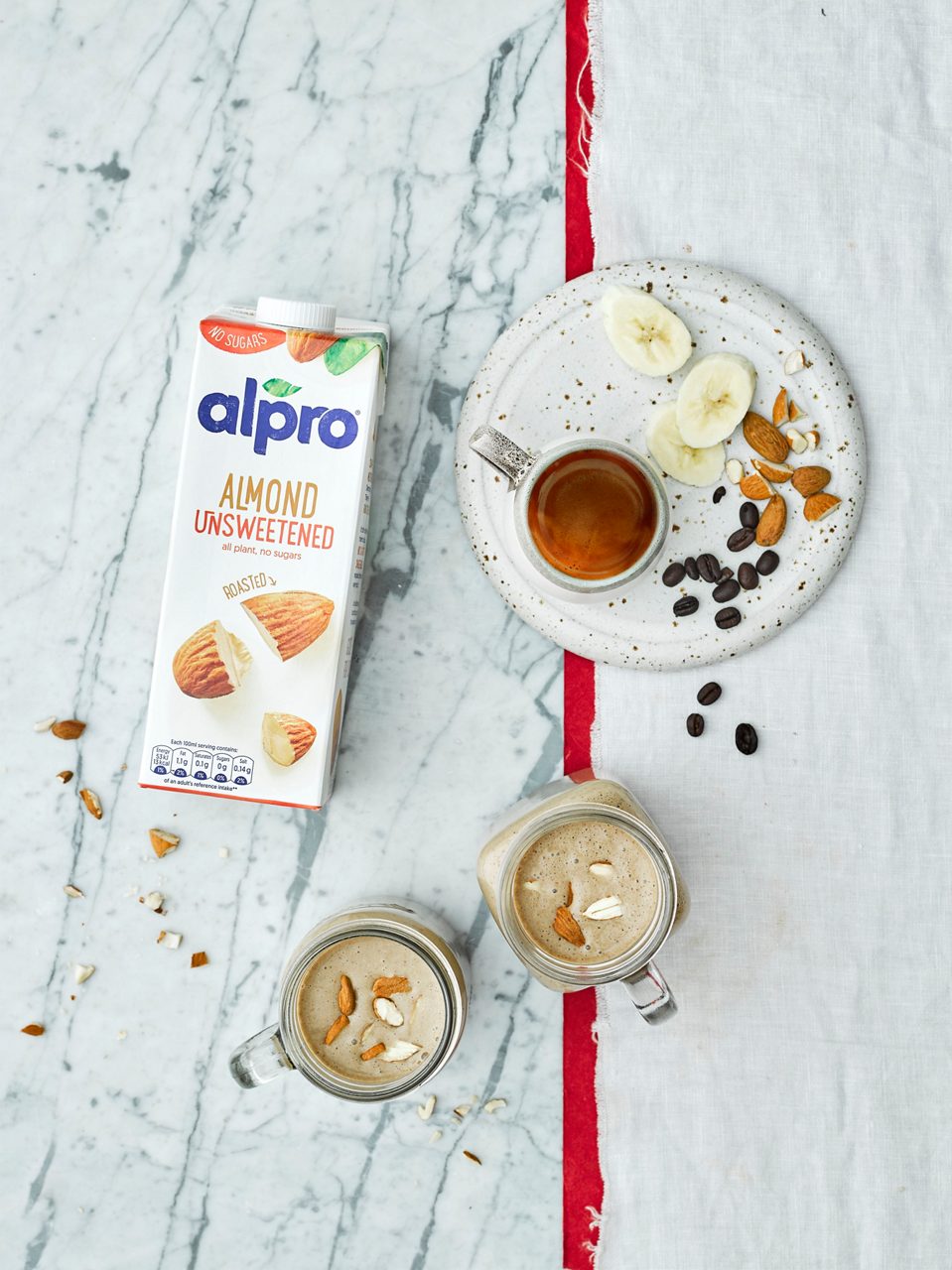 CC15BEDD-9F31-482D-980859690AB9B42B<br>R+T-Alpro_UnsweetenedRecipes-Smoothie_02331.jpg<br>Serves: 2
Total time: 5 minutes, plus freezing

Ingredients: 
2 ripe bananas, peeled, chopped and frozen
1 tbsp almond butter
400ml Alpro Almond Unsweetened drink
50ml black coffee, cold
Ice


Method:
1.	Put all the ingredients into a blender and blitz until smooth. Serve straight away.