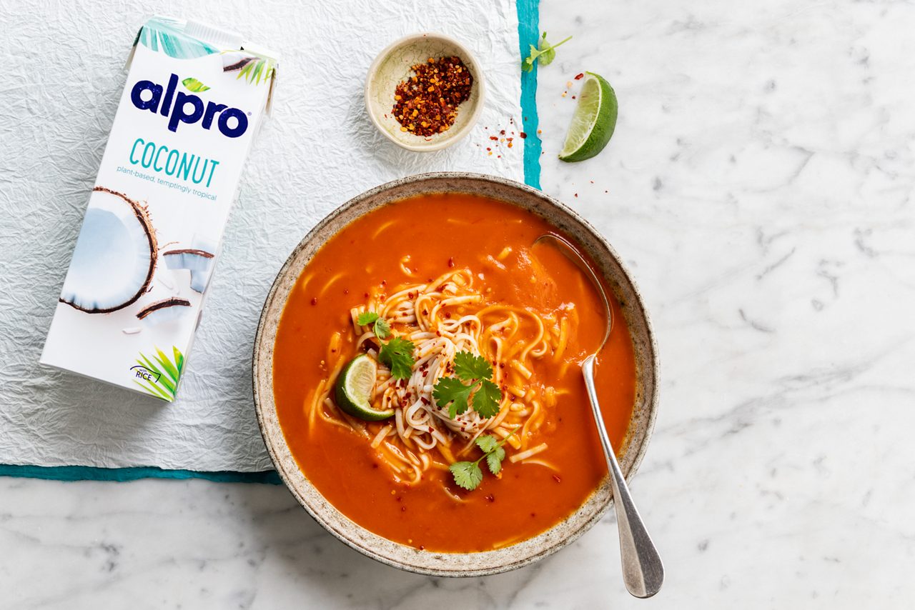 23E9F0A9-502F-4053-9C0C246AB9A6B950<br>A_Moments_Moments_Master_Recipe_Image____Drinks_Origins_Coconut_NA_TetraUHT_1l_HR_RedThainoodlesoup 3x2-036.tif<br>red_thai_noodle_soup_title	Red Thai Freezer Soup
red_thai_noodle_soup_subtitle	Get ahead of the weather, with this ready prepped winter warming Thai soup!
red_thai_noodle_soup_ingredients	"2 large sweet potatoes (scrubbed, but no need to peel)
1 red onion
2 garlic cloves
5cm ginger
2 sweet red peppers
110g Thai red curry paste
1L Alpro Coconut drink
300g whole wheat noodles, cooked
Fresh coriander
Dried chillies, ground
1 lime"
red_thai_noodle_soup_preparation	"1 Roughly chop the sweet potato, red onion, garlic, ginger and sweet pepper. Pop the lot into a Ziplock freezer bag. (The stand-up ones designed for easy pouring are ideal.)
2 Add the Thai red curry paste and Alpro Coconut drink to the veggies. Seal and freeze until you need it.
3 When you're ready, just take it out of the freezer.
4 Bring it to a boil and simmer till the veggies are soft, then whizz with a stick blender until you have a smooth, creamy, deliciously spicy soup. Serve and enjoy!"
red_thai_noodle_soup_tags	veggie, vegan, lactose free
red_thai_noodle_soup_url	/Red-Thai-noodle-soup
red_thai_noodle_soup_info	(Recipe type: LUNCH/DINNER (Prep time: 10 min) (cooking time: 20-25 min) (cooling time: x ) (servings: for 4-6) (season: all seasons)
red_thai_noodle_soup_lactosetip	/
red_thai_noodle_soup_veggietip	/
red_thai_noodle_soup_trendtip	/
red_thai_noodle_soup_glutentip	use gluten free noodles
red_thai_noodle_soup_product	Alpro Coconut drink
red_thai_noodle_soup_searchterms	Alpro, Alpro recipe, coconut, soup, thai, winter soup, freezer, noodle, red thai, dinner, plant based