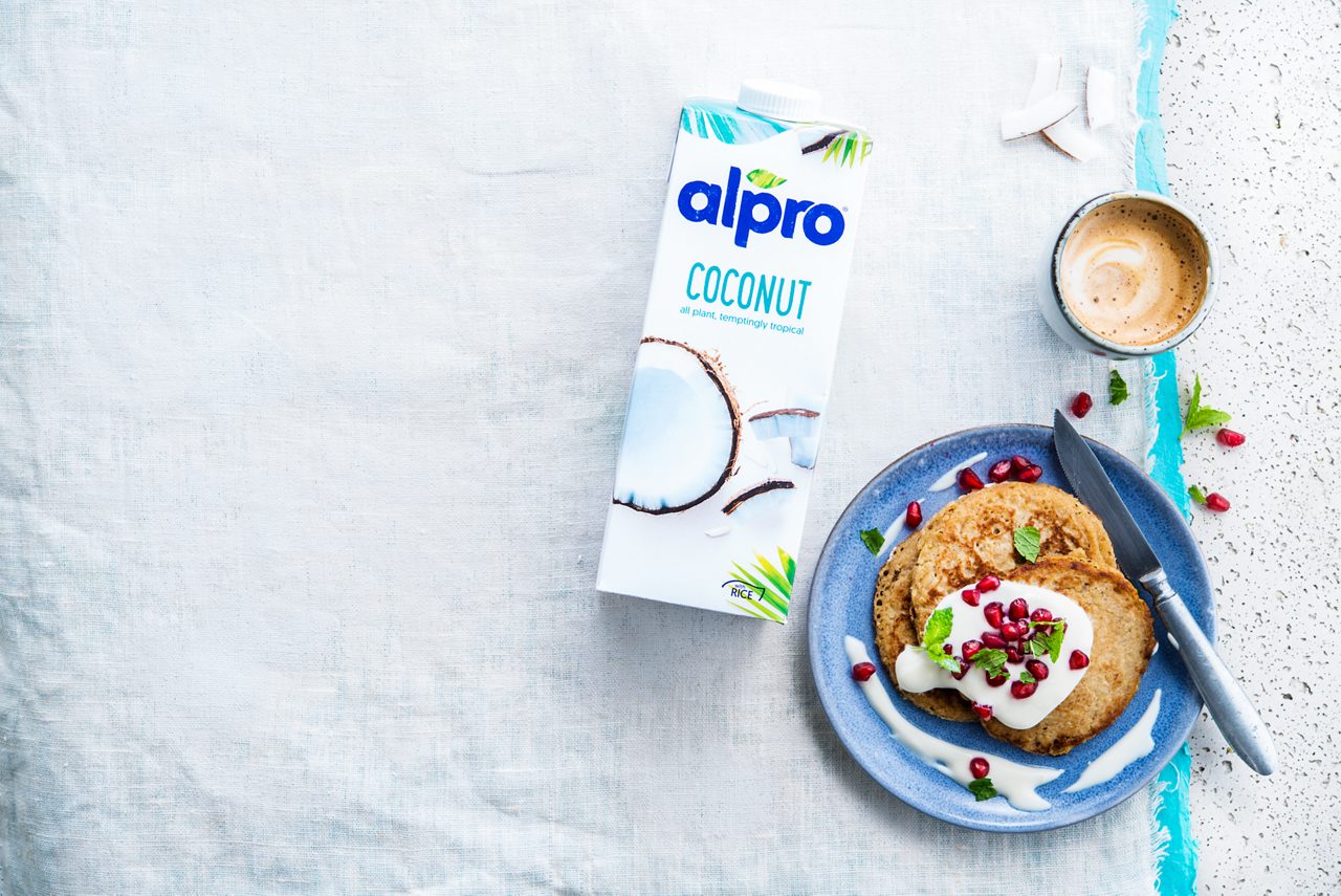 43496DE6-4451-49F9-A04368EB64012AD1<br>A_CoconutDrink_NA_Master_Recipe_Image_buckwheatbananapancakespackshot___Drinks_NA_Rice_Coconut_TetraUHT_1l_HR_hori.tif<br>Buckwheat Banana pancakes

Buck up your taste buds with buckwheat & banana pancakes using Alpro Coconut Drink

"For the pancakes:
200ml Alpro Plain with Coconut 
100-150ml Alpro Coconut Drink
250g buckwheat flour
1 large ripe banana
1 tsp baking powder
A pinch of salt
1 tbsp coconut or groundnut oil, or Alpro Margarine for Baking and Frying

Toppings:
12 tbsp Alpro Plain with Coconut 
8 tbsp pomegranate seeds
4 tbsp chia seeds (optional)"

"1. Why wait for Pancake Day! Mix the buckwheat flour, salt and baking powder in a bowl. In another bowl, mash the banana and mix with the Alpro Plain with Coconut and the Coconut Drink . 
2. Combine the wet and dry mixtures and blend until you have a nice, smooth batter. If it’s too thick, just splosh in a little more Coconut Drink.
3. Next, heat up some coconut oil on a medium heat. Ladle around 3 tbsp of batter into the pan and cook for 3-4 minutes, flip over and cook for another 2 minutes. Carry on until you’ve used all your batter.
4. Serve topped with the Alpro Plain with Coconut and pomegranate seeds. Chia seeds, too, if you like. Breakfast, dessert, snack – make these any time you feel like a yummy plateful of plant-based goodness!"