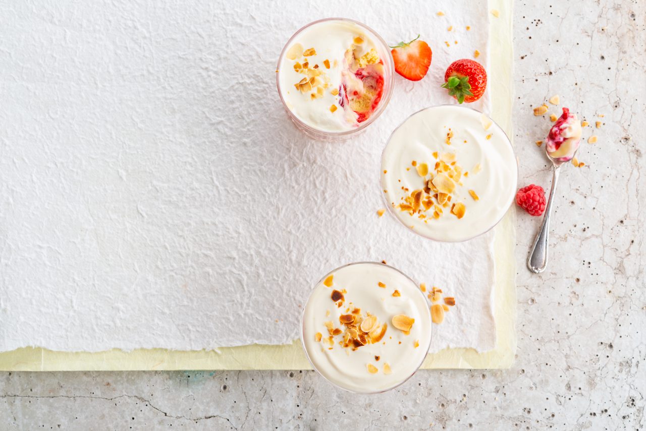 389962E5-D0DB-46B2-A2546F4ADFCC8881<br>A_GFY_NA_Master_Recipe_Image_SummerFruitTrifle__Dessert_NA_Vanilla_NA_Pot_250g_HR_horizontal-351.tif<br>Summer Fruit Trifle 
A fresh, fruity finish to a meal made with Alpro Desserts Vanilla + Alpro Plain plant-based alternative to Greek style yogurt
"For the sponge 
3 eggs
75g caster sugar
75g self-raising flour
1 tsp vanilla extract
1 tblsp boiling water
The rest
400g fresh strawberries & raspberries (add 4-6 tbsp water) or frozen fruit (defrosted)
6 tbsp kirsch or amaretto liqueur (optional), or use orange juice
525g Alpro® Desserts Vanilla 
400g Alpro® Plain plant-based alternative to Greek style yogurt
25g flaked almonds, toasted"
"1. Get ready. Pre-heat your oven to 180ºc/170ºc fan/gas 4, and grease or line a 23 x 23 x 6 cm square cake tin. Find yourself a pretty glass bowl to put your trifle in. (18-20cm x 10cm deep is the perfect size, and the glass will show off all your lovely layers.) Toast your flaked almonds in a shallow frying pan over a medium heat, turning them with a spatula to prevent burning as they cook really quickly. It’s well worth that little extra effort as they taste so wonderful toasted and the extra crunch is an added bonus. As soon as they start to colour tip out of the pan and let them cool down.
2. Make the sponge. Separate the eggs into two bowls. Put the whites into a medium bowl and whisk until they form soft peaks, then carry on whisking you gradually add the sugar then finally add the yolks
3. Sieve the flour and gently fold it into the mixture with a metal spoon, keeping in that all-important air. Add the vanilla extract and the boiling water around the edge of the bowl then carefully fold it in, too. Pour into your tin and bake in the oven for 12-15 mins, until well risen and ‘springy’ when touched, then let it cool down on a wire rack.
4. Over a low heat, cook the fresh fruit in a small saucepan along with 4-6 tbsp water until soft, taking care not to let the water evaporate. Then put it to one side to cool. (Frozen fruit won’t need cooking.)
5. Now the fun part, putting all the layers together. Cut the sponge into 9 pieces and cut each slice horizontally through the middle, (so you have 18 pieces of sponge). Using half of the slices, line the base and sides of your bowl. Soak the sponge with the liqueur or orange juice, making sure it’s even.
6. Spoon half the fruit over the first layer of sponge. (If you’re using frozen berries, you won’t need all of their juice.) Now add the rest of the sponge and arrange the other half of the fruit on top of that.
7. Spoon on the Alpro® custard followed by a generously thick layer of the Alpro® Plain plant-based alternative to Greek style yogurt. Sprinkle the toasted almonds over the top, and if you have some fresh fruit to hand that’ll just finish it off nicely."
lactose free, veggie
/summer-fruit-trifle
(Recipe type: DESSERTS (Prep time: 20 min) (cooking time: 15 min) (baking time: x min) (cooling time: x min) (servings: +/- 6 persons) (season: all year) (pool: 1) NOT TO BE TRANSLATED
/
/
/
/
Alpro Desserts Vanilla + Alpro Plain plant-based alternative to Greek style yogurt
Alpro, Alpro recipe, desserts, trifle, summer dish