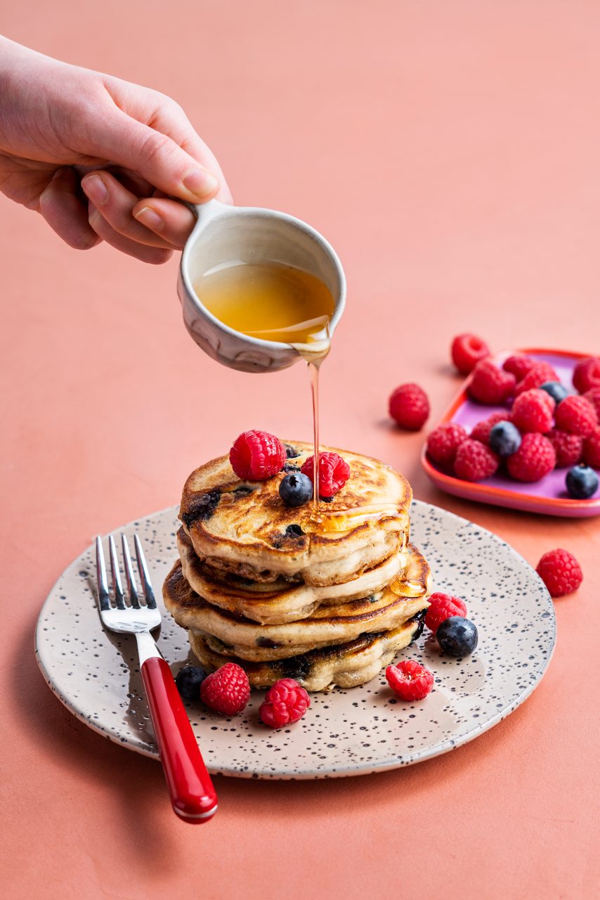 D7E5A061-1F35-4CE4-A2F51C4CE10977A1<br>A_NA_NoSugars_Master_Recipe_Image_Pancake_Blueberry_Recipe_NA_Drinks_NS_Oat_NA_TetraUHT_pancakes_redfruits-042.tif<br>These pancakes are flipping oatsome!  

350ml Alpro Oat Drink No Sugars
1 banana
1 tsp vanilla extract
Pinch salt
300g self raising flour
16g baking powder
1/2 tsp bicarb
250g fresh blueberries

To serve:
Fresh fruit and (optional) agave syrup 

1. Start with the pancake batter. Mash the banana in a bowl. Whisk in the Alpro Oat Drink No Sugars, vanilla extract and salt.
2. Sift the self raising flour, baking powder and bicarb into a separate, big bowl and tumble together. Pour the wet mixture over the dry stuff and whisk again until you have a lovely smooth batter.
4. Set it aside and let it stand for 20 minutes. Then gently stir in the blueberries – you don’t want blueberry mush!
5. Heat a drizzle of oil in a frying pan. Or pancake pan if you have one. Pour in about 2 tablespoons of batter and cook for 1-2 mins, until the base sets and bubbles pop out all over the top. Flip and cook the other side for a minute. Repeat until all your batter is used up.
6. Stack them up with the fresh fruit and a drizzle of agave syrup, if you like. Then watch them fly off the plate like hot... pancakes!
lactose free, veggie, vegan
/fluffy-blueberry-pancakes
(Recipe type: DESSERT/BREAKFAST (Time: 40 min) (servings: +/- 12-13 small pancakes) (season: all seasons)
/
/
For a different take, try raspberry instead of blueberry 
Use gluten free flour
Alpro Oat Drink No Sugars
Alpro, Alpro recipe, pancake, breakfast, blueberry