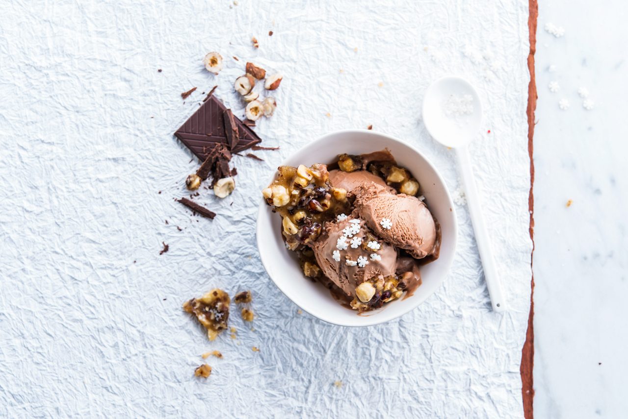 E1CC1914-2001-447D-A57AA53F53047654<br>A_IceCream_NA_Master_Recipe_Image_icecreamdessert___IceCream_Multi_Hazelnut_Chocolate_Tub_500ml_HR_horizontal.tif<br>Choconut Ice Cream Dessert 

A super-nutty delicious dessert with Alpro Chocolate Hazelnut Ice Cream 

"500g Alpro Chocolate Hazelnut Ice cream 
100ml maple syrup 
60g whole hazelnuts 
A pinch of salt 
6 tbsp sprinkles"

"1.	Roast the hazelnuts in a frying pan (without oil) until they brown a little and smell lovely and toasty. Tip them out and let them cool a little, then chop finely.
2.	In the still warm frying pan, cook the maple syrup for five minutes until it thickens and turns a deep golden colour. 
3.	Stir in the chopped hazelnuts and a pinch of salt then pour the mixture in a thin layer onto a baking tray lined with paper. When it’s completely cool and hard, break into shards.
4.	Divide the Alpro Hazelnut Chocolate Ice cream between four glasses or dessert bowls, decorate with the hazelnut praline pieces and chocolate sprinkles. Doubly nutty, decadently delicious!"