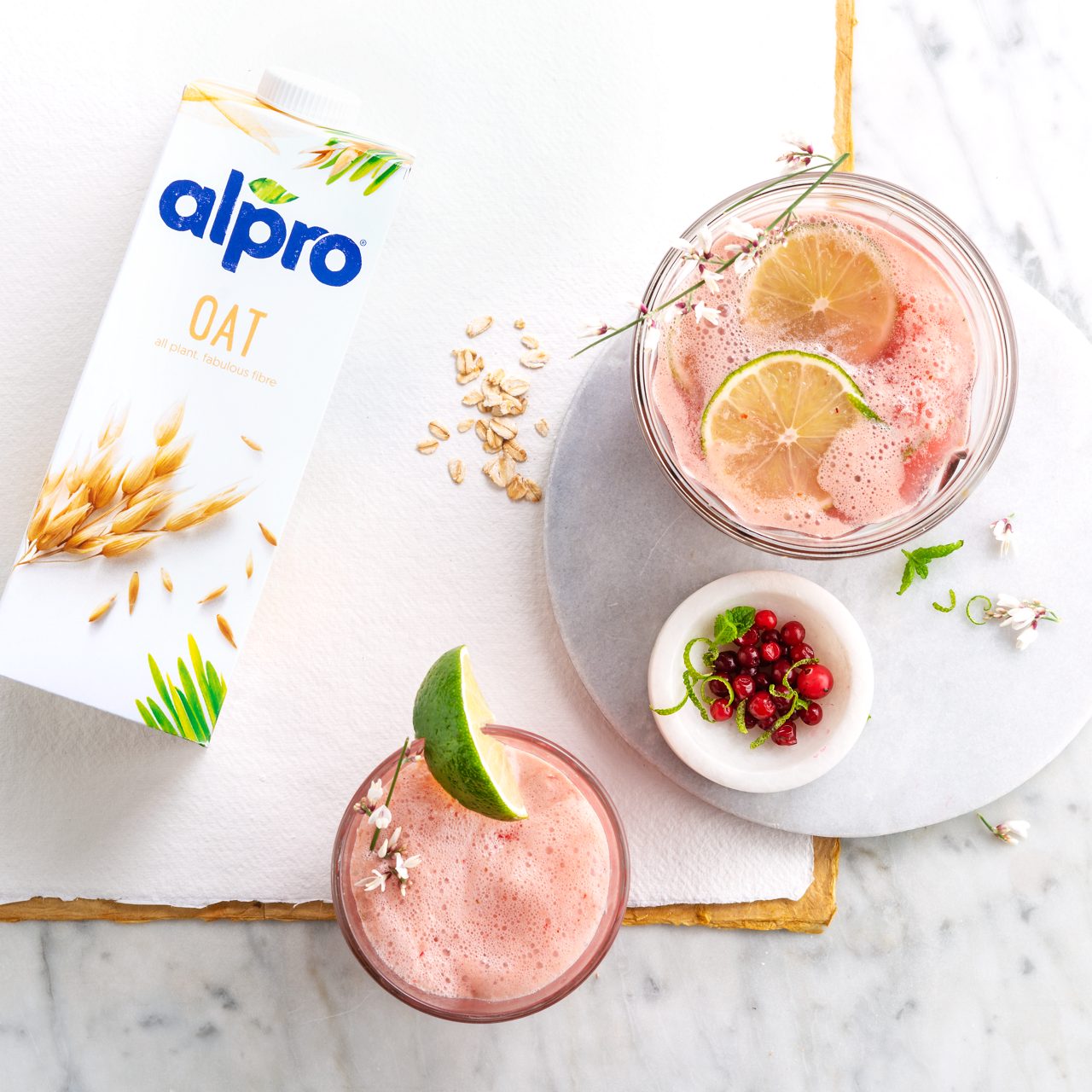 88807E1C-71AE-4CF7-A5A11F8611377B56<br>A_GFY_NA_MASTER_Recipe_Image_MocktailOatPunch_1x1___Drinks_NA_Oat_NA_TetraUHT_1l_HR_horizontal-021.tif<br>Oat and cranberry cooler
A refreshing, summer mocktail with zesty cranberry and Alpro Oat Drink Original
"400ml cranberry juice
320ml apple juice
160ml lime lemonade
80ml Alpro Oat Drink Original
60g small cranberries, fresh
1 lime
4 tbsp crushed ice"
"1. Whizz up this perfect summer punch in seconds! Pop all the ingredients except the ice into your blender.
2. Zizz until you have a nice layer of frothy foam.
3. Pour into chilled glasses over the crushed ice, scatter with fresh cranberries and add a slice of lime.
4. If you like your drinks tart and tangy, add extra fresh cranberries to the blender. Super sippable and so sophisticated!"
(Recipe type: drinks (Prep time: 5 min) (servings: +/- 4 persons) (season: all year) (pool: 1)