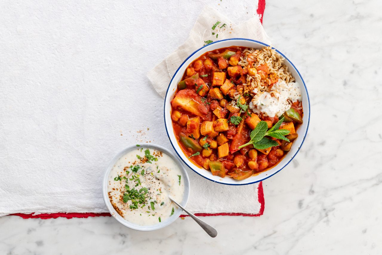 963A5250-93DB-4A03-ABC5105E910B44F5<br>A_GFY_NA_Master_Recipe_Image_SweetPotatoCurry__PBAY_NS_Soya_NA_POT_500g_HR_horizontal-089.tif<br>Sweet Potato and Chickpea Curry
Quicker than a takeaway and made with Alpro Plain No Sugars plant-based alternative to yogurt
"For the curry:
1 medium size sweet potato, peeled and cut into 2cm chunks
2 tbsp rapeseed or sunflower oil, plus extra if needed
2 medium size onions, finely diced
3 garlic cloves, crushed
10g fresh root ginger, peeled and finely grated
1 tsp sweet paprika
2 tsps ground turmeric
1 tsp medium curry powder
¼ tsp hot chilli powder
1 tsp ground coriander
1 tsp garam masala
4 green cardamom pods, crushed
227g can chopped tomatoes
1 tbsp tomato purée
½ green pepper, deseeded and cut into 1cm pieces
1 green chilli, finely diced
250ml vegetable stock
2 fresh tomatoes, quartered
1 tsp salt,
400g can chick peas, drained and rinsed

For the garam masala raita:
150g Alpro Plain No Sugars plant-based alternative to yogurt
1 tsp garam masala
½ tbsp dried mint

Rice to serve"
"1. Start with a bit of roasting. Preheat the oven to 190C/170 fan/gas mark 5 and line a baking tray with baking parchment. Toss the sweet potato with 1 tbsp oil and spread out on the tray, then bake for 20-25 minutes until soft and slightly browned along the edges.
2. While that’s happening, add the rest of the oil to a medium saucepan and warm over a low-medium heat. Fry the onions, garlic and ginger for 8-10 minutes, or until very soft. Stir in the paprika, turmeric, curry powder, chilli powder, coriander, garam masala and crushed cardamom pods to make a nice thick curry paste. Cook for 1-2 minutes, adding a little extra oil if it gets dry.
3. Pour in the canned tomatoes, stir in the tomato purée and cook for 2-3 minutes to thicken up again. Mix in the vegetable stock, green pepper, green chilli, fresh tomatoes and salt, then siimmer gently on a low heat for 35-45 minutes. Finally add the chickpeas and roast sweet potato and heat until they’re warmed through.
4. To make the garam masala raita, just mix all the ingredients together and season to taste. Serve on the side with the curry and rice for a touch of tangy contrast."
lactose free, gluten free, veggie, vegan
/sweet-potato-curry
(Recipe type: MAINS (Prep time: 15 min) (cooking time: 50 min) (baking time: x min) (cooling time: x min) (servings: +/- 2 persons) (season: all year) (pool: 1) NOT TO BE TRANSLATED
/
/
/
/
Alpro Plain No Sugars plant-based alternative to yogurt
Alpro, Alpro recipe, curry, sweet potato curry, Indian, main, rice