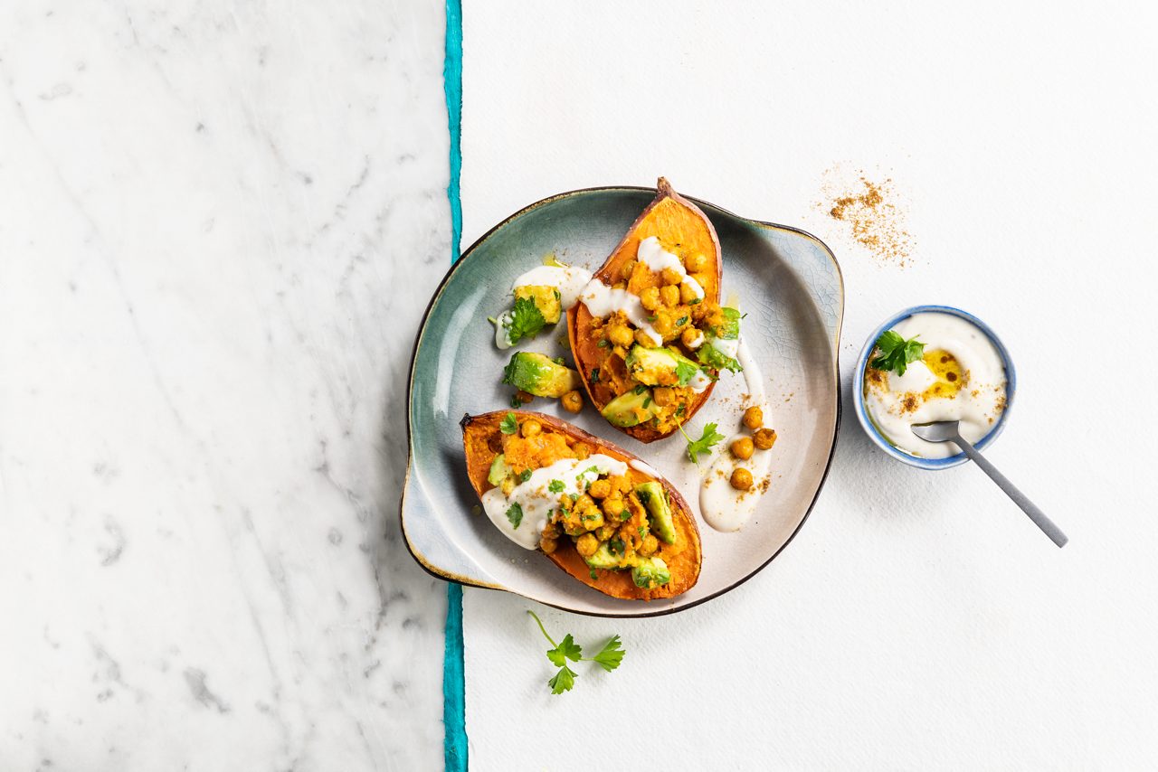 A10C6175-B8C2-4D40-ABFA0103E06B3441<br>A_GFY_NA_Global_Recipe_Image____GreekStyle_NA_Coconut_NA_Pot_400g_HR_OvenBakedSweetPotato_3x2.tif<br>4 medium-sized sweet potatoes, unpeeled, cut in half lengthwise 
400g chickpeas, drained  
1 garlic clove, minced  
½ tsp cumin  
½ tsp curcuma
1 tsp smoked paprika    
Vegetable oil  
1 ripe avocado, diced   
30g chopped parsley   
For the sauce:
250ml Alpro Greek style coconut  
½ tsp cumin  
1 tbsp olive oil  
salt and pepper 

1.	Start by preheating your oven to 200°C 
2.	Wrap each sweet potato half in aluminium foil, arrange on a baking tray and bake in the oven for about 45 minutes, or until they're tender when you try them with a fork. Once they're cooked and slightly cooled, scoop about half of the flesh out. Mash it in a bowl and put to one side until you're ready, along with the skin shells.
3.	In a bowl, mix the chick peas with the garlic and spices so they are well coated. Spread them out on a baking tray and roast in the oven for 25 minutes, giving them a stir around every now and then. 
4. When the chickpeas are done, mix them together with the mashed sweet potatoes, diced avocado, chopped parsley and a drizzle of olive oil. 
5. In a separate bowl, whisk together the Alpro Greek Style coconut, cumin, olive oil, salt and pepper to make the sauce.
5. Fill the sweet potato skins with the chickpea mixture, then finish with a generous dollop of the dreamy, creamy coconut sauce on top. Delicious! 

(Recipe type: Lunch/dinner (Prep time: 15 min) (baking time: 45 minutes ) (cooling time: ) (servings: +/- 2 persons) (season: all season)

! No GFY claim possible !

Caption: 
When you’re craving sweet AND savoury, there’s only one thing for it: loaded sweet potatoes. Phwoar! Now, stop salivating, and start cooking. (mouth watering emoji, heart eye-emoji)