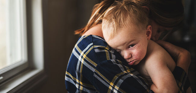 Baby peeking from mother arms