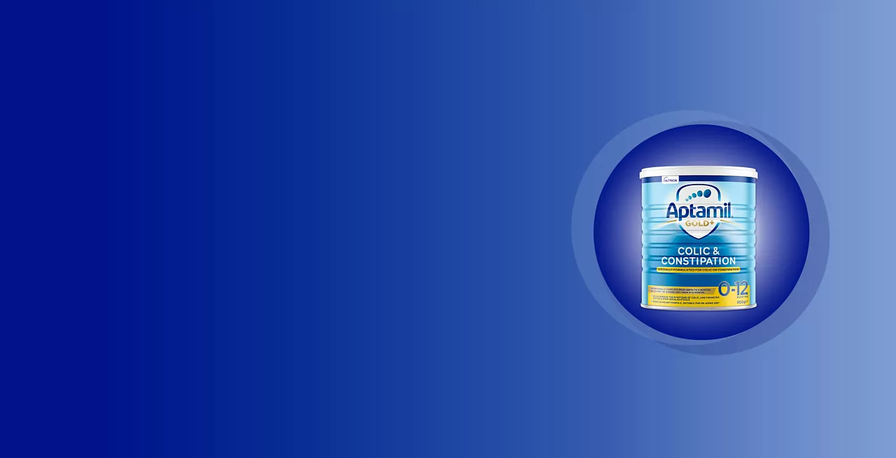 Aptamil Colic & Constipation formula packaging displayed against a gradient blue background. The product is clearly labeled for infants aged 0-12 months. The design features a circular spotlight effect highlighting the container. The text 'Colic & Constipation' and '0-12 months' are prominently visible.