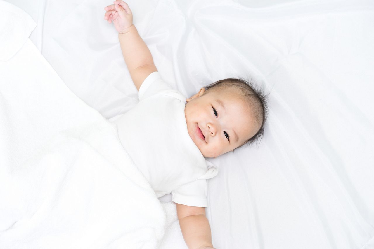Portrait of a newborn Asian baby on the bed 