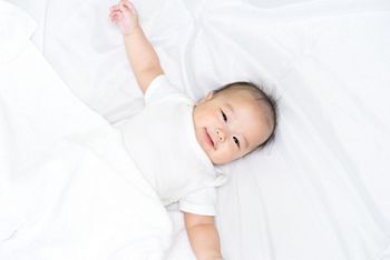 Portrait of a newborn Asian baby on the bed 
