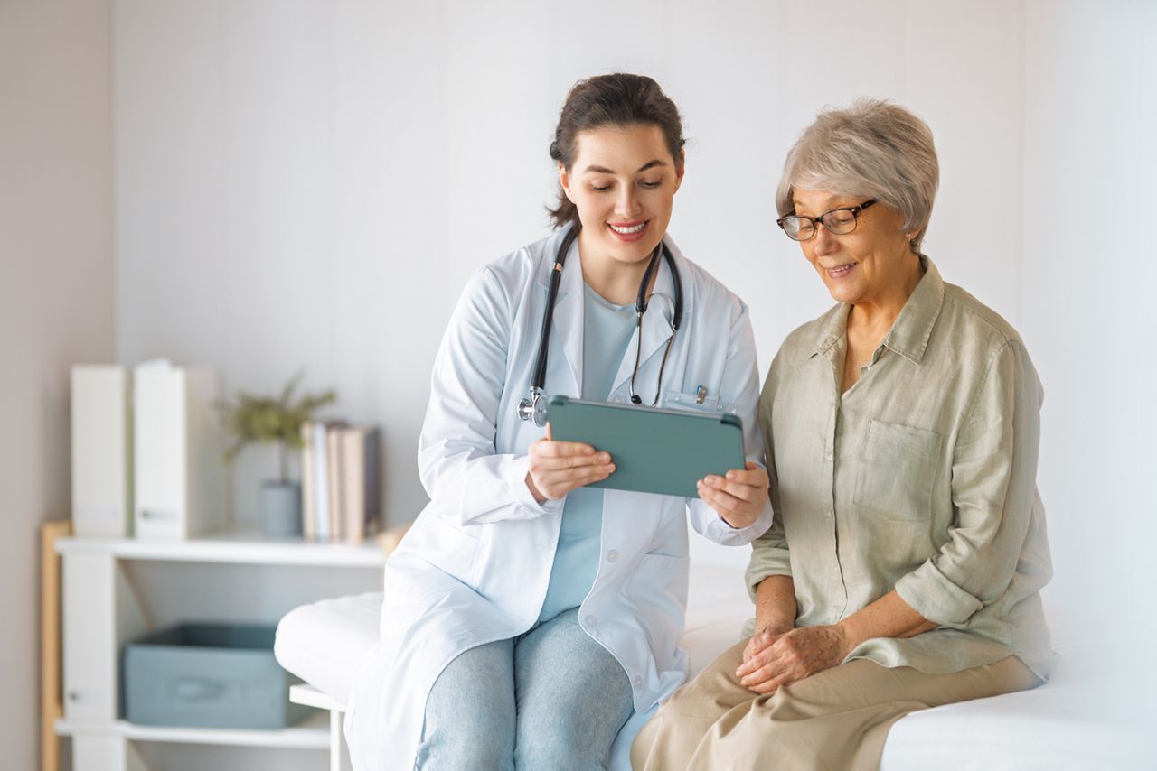 Female patient listening to a doctor in hospital.