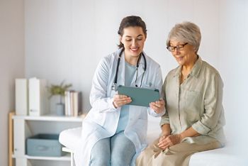 Female patient listening to a doctor in hospital.