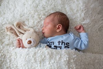 Little newborn baby sleeping with toy, baby with scin rash, child dermatitis symptom problem rash, newborn suffering atopic symptom on skin. concept child health