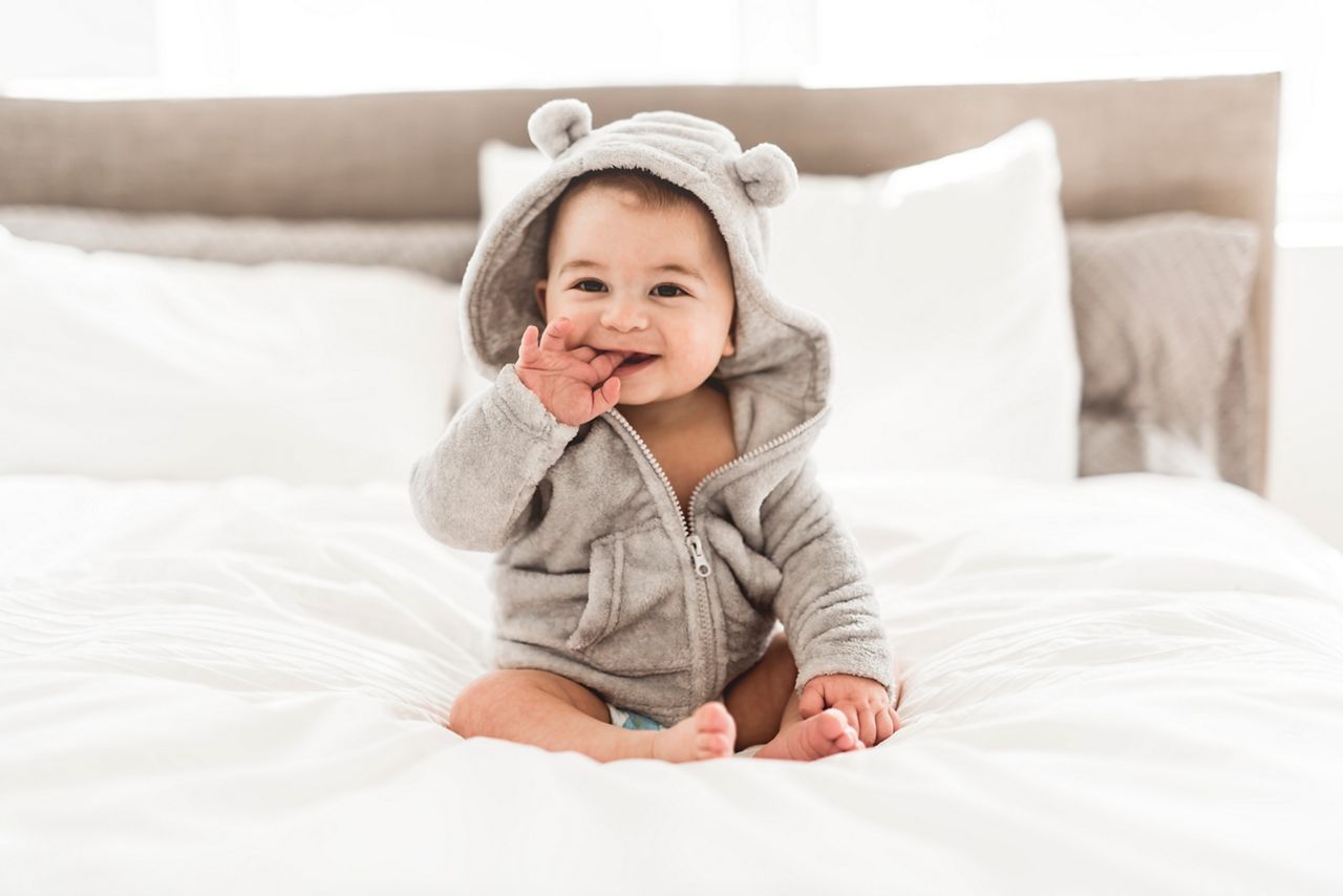 A Portrait of a baby boy on the bed in bedroom