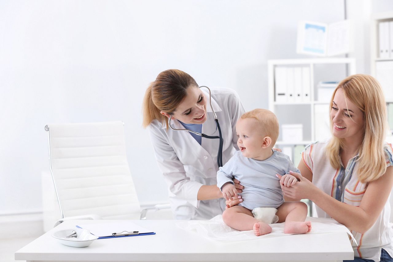 Woman with her baby visiting children's doctor in hospital