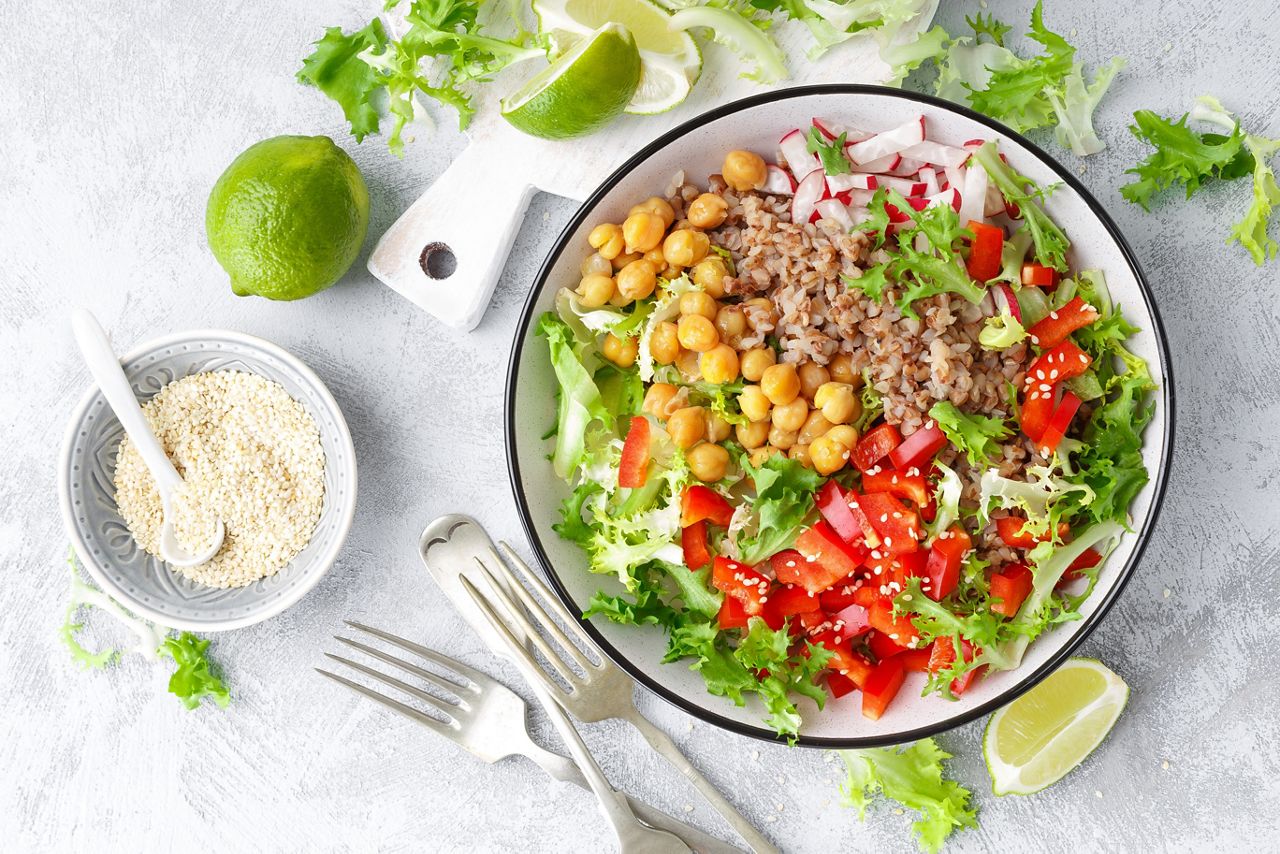 Healthy and delicious bowl with buckwheat and salad of chickpea, fresh pepper and lettuce leaves. Dietary balanced plant-based food. Vegan and vegetarian dish. Top view. Flat lay
