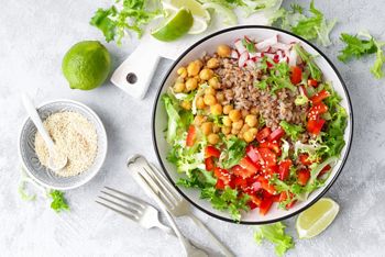 Healthy and delicious bowl with buckwheat and salad of chickpea, fresh pepper and lettuce leaves. Dietary balanced plant-based food. Vegan and vegetarian dish. Top view. Flat lay